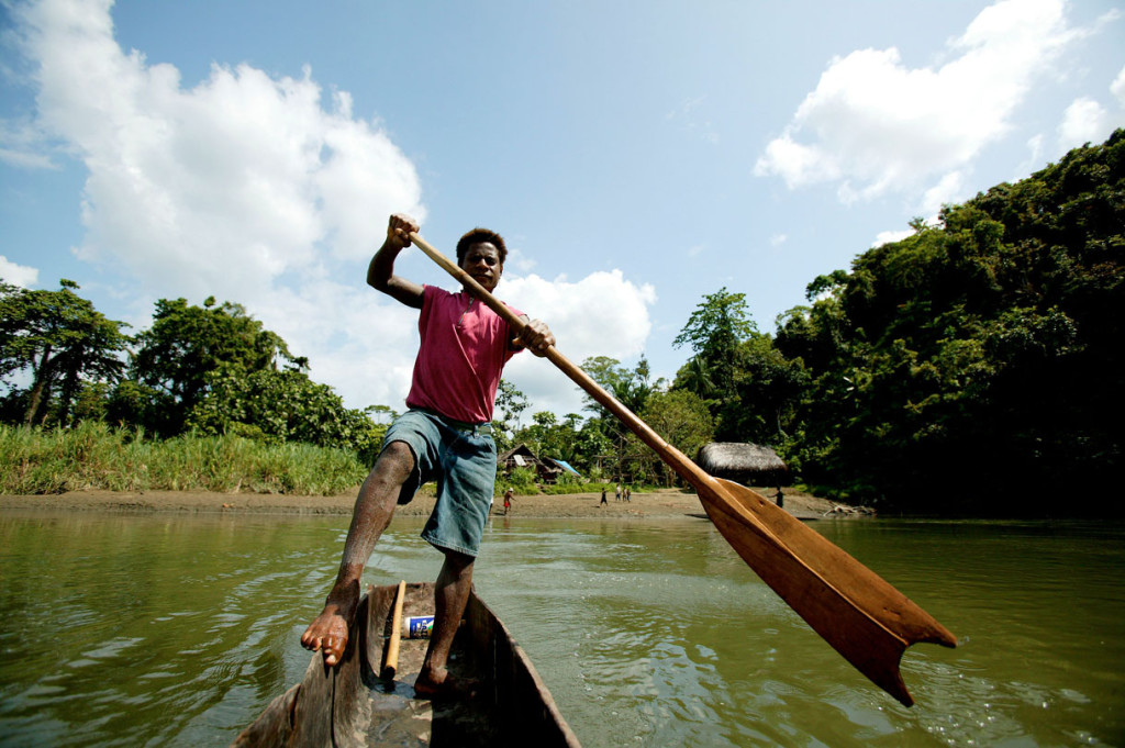 Pukapuki man in a dug-out canoe on the April River, a tributary of the mighty Sepik River, Papua New Guinea. WWF is developing a model for river basin management to protect important freshwater and forest resources that offer significant habitat for threatened species as well as providing subsistence livelihoods for communities. 